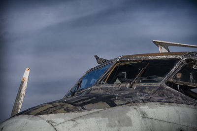 Low angle view of abandoned airplane against sky