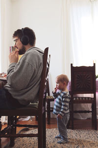 Rear view of friends sitting at home
