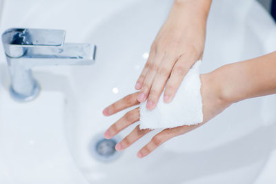 Close-up of woman hands in bathroom