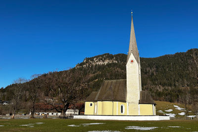 Low angle view of church against clear blue sky