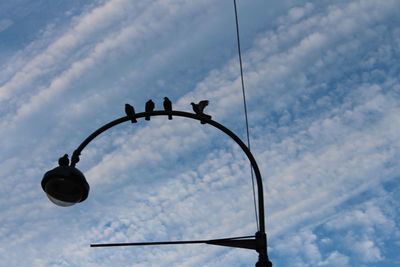 Low angle view of street light against sky