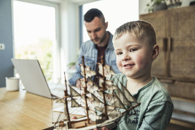 Father and son on table