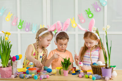 Portrait of siblings playing with toys at home