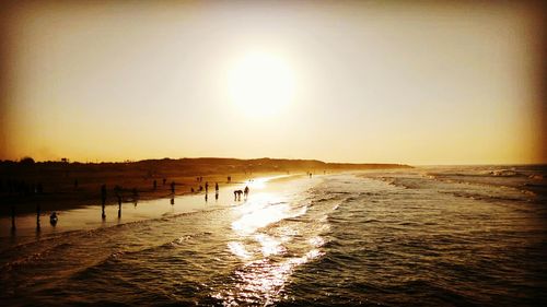 Scenic view of beach against sky during sunset