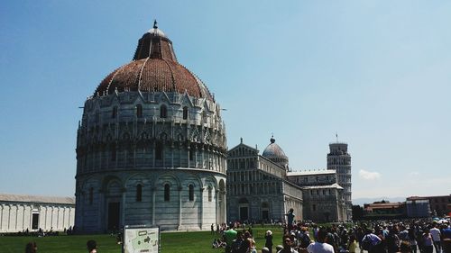 People outside piazza dei miracoli and leaning tower of pisa against clear sky