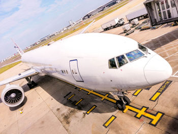 High angle view of airplane on airport runway against sky