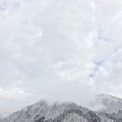 Scenic view of mountains against cloudy sky