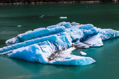 High angle view of glacial ice floating in the water