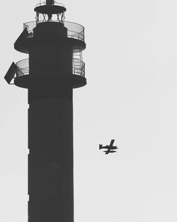 Low angle view of airplane against clear sky