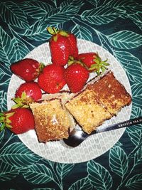 High angle view of strawberries in plate on table