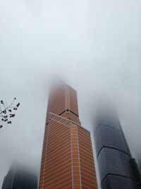 Low angle view of modern buildings against sky in city