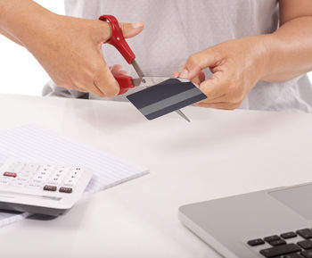 Midsection of man using mobile phone on table