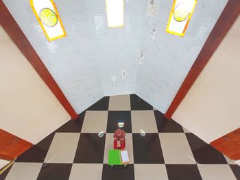 High angle view of person walking on tiled floor