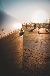 Surface level of footpath by street against sky