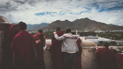 Rear view of people looking at mountains