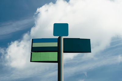 Low angle view of road sign against sky