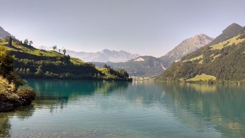 Scenic view of lake and mountains against clear sky