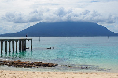 Scenic view of sea against cloudy sky