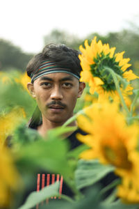 Portrait of man with yellow flowers