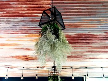 Low angle view of bell hanging on wall