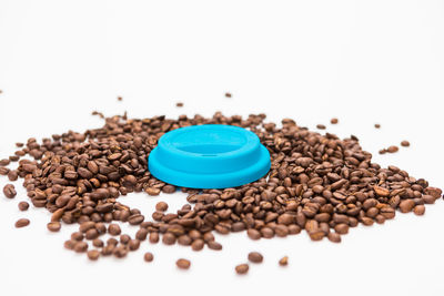High angle view of coffee beans against white background