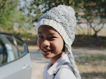 Portrait of boy wearing hat in car