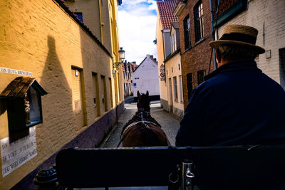 Rear view of man on street in city