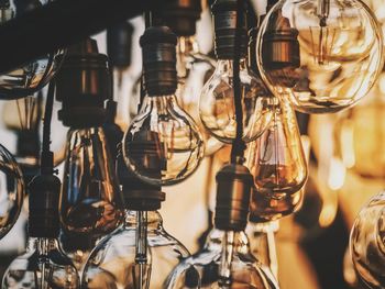 Close-up of light bulbs hanging in row