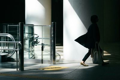 Side view of a woman walking on corridor