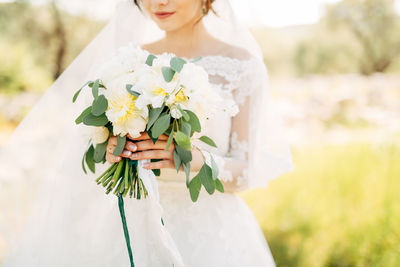 Woman holding flower bouquet