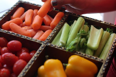 Cropped image of woman holding container with various vegetables