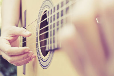 Cropped image of hand playing guitar