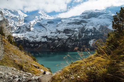 Scenic view of lake and snowcapped mountains against sky