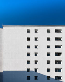 Low angle view of building against clear blue sky