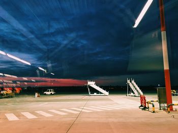 Airplane on airport runway against sky