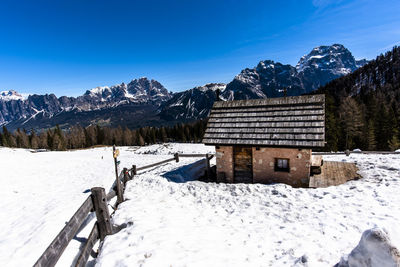 Snow covered mountains against blue sky