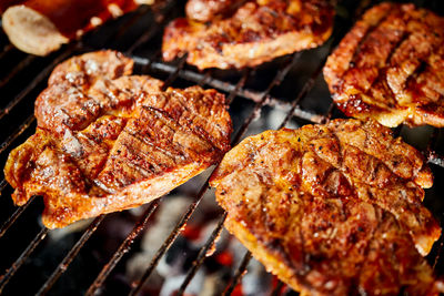 High angle view of meat on barbecue grill