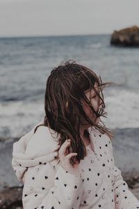 Woman on beach against sky