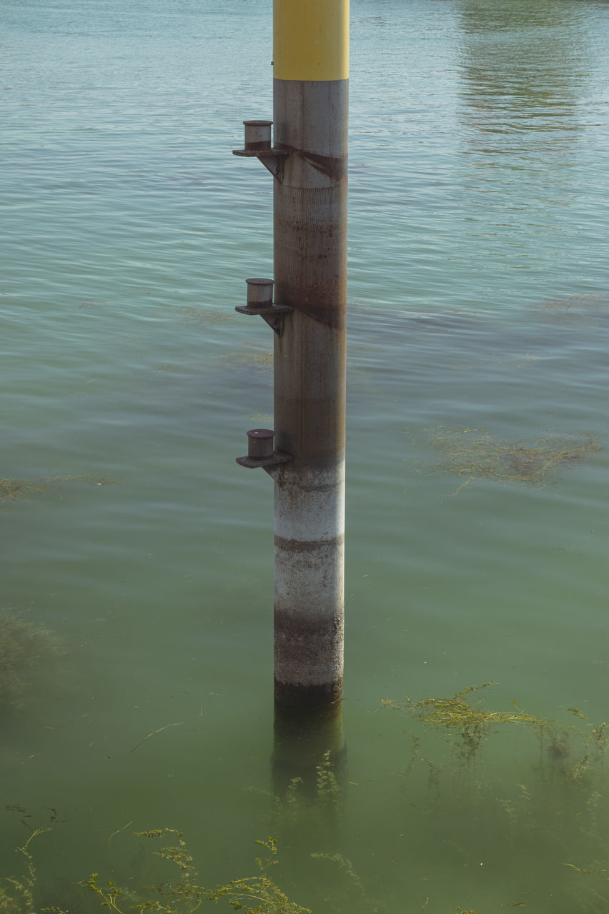 water, reflection, no people, sea, post, day, nature, waterfront, tranquility, outdoors, wooden post, wave, green, shore, beauty in nature, rippled, wood, pole, tranquil scene