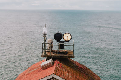 Lifeguard hut in sea against sky