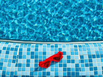 High angle view of red floating on swimming pool