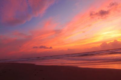 Scenic view of sea against romantic sky at sunset