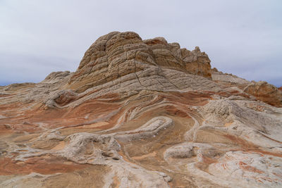 Low angle view of rock formation on land against sky