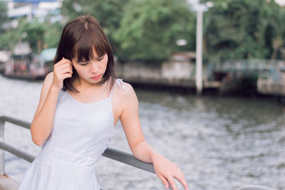 Young woman standing on bridge