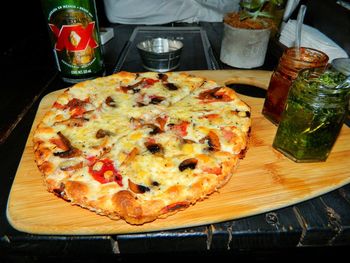 High angle view of pizza served on table