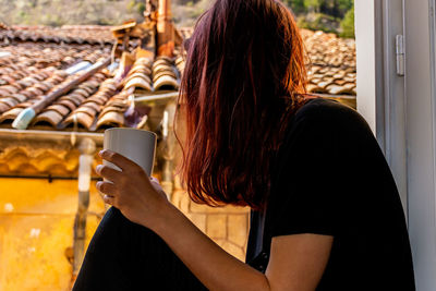 Midsection of woman using mobile phone