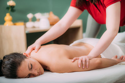 Back massage in a massage salon, woman having a relaxing back massage.