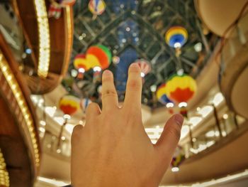 Close-up of hand holding carousel in amusement park