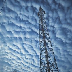 Low angle view of communications tower against sky