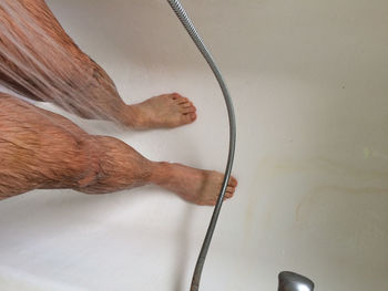 Low section of man bathing in bathroom